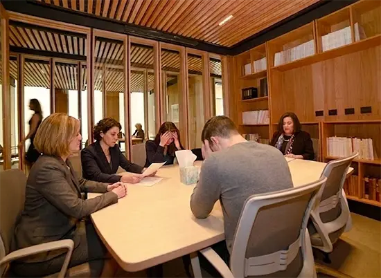 Attorneys meeting with a couple in the firm's conference room